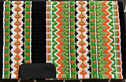 SOLD- Black base with orange and greens, with white accents $195